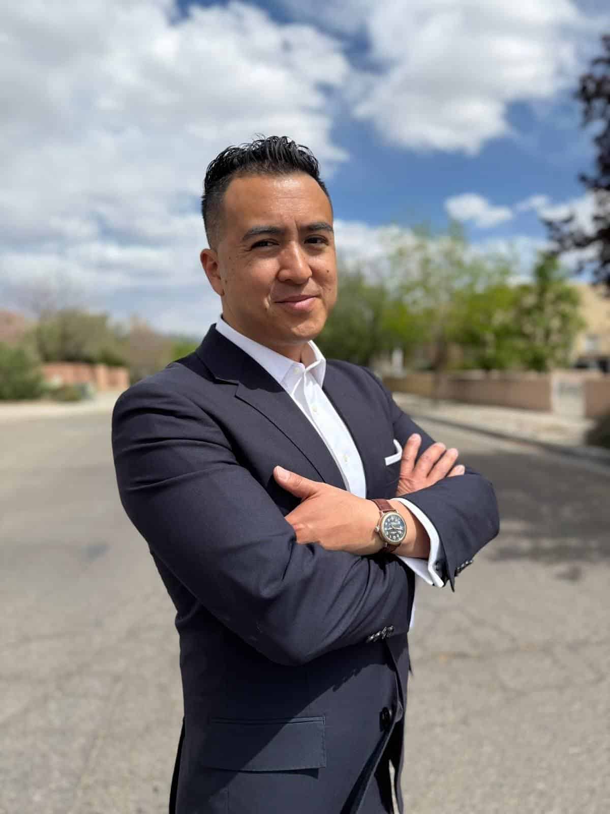 Alex in blue suit standing in the middle of the road